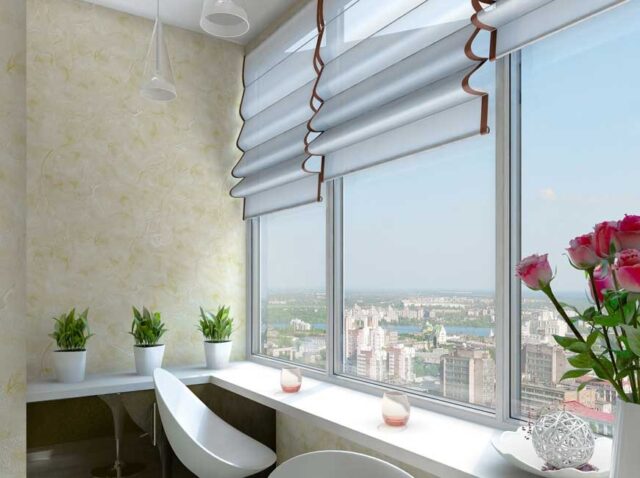 7565381a-2a7b-4e63-b5fa-b3a2abb8e345 Roman shades on large modern apartment windows with city view and indoor plants