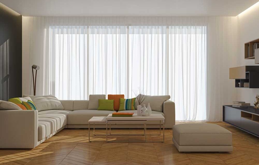 Why More Homeowners Are Choosing Motorised Sheer Curtains Modern living room featuring motorised sheer curtains with smart light control and elegant interior design
